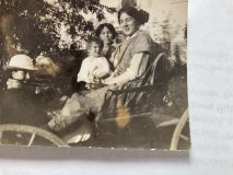 Hilda Lamont driving, Lily McIntosh with Marjorie Lamont on her lap; Two children seated in front unknown; About 1913